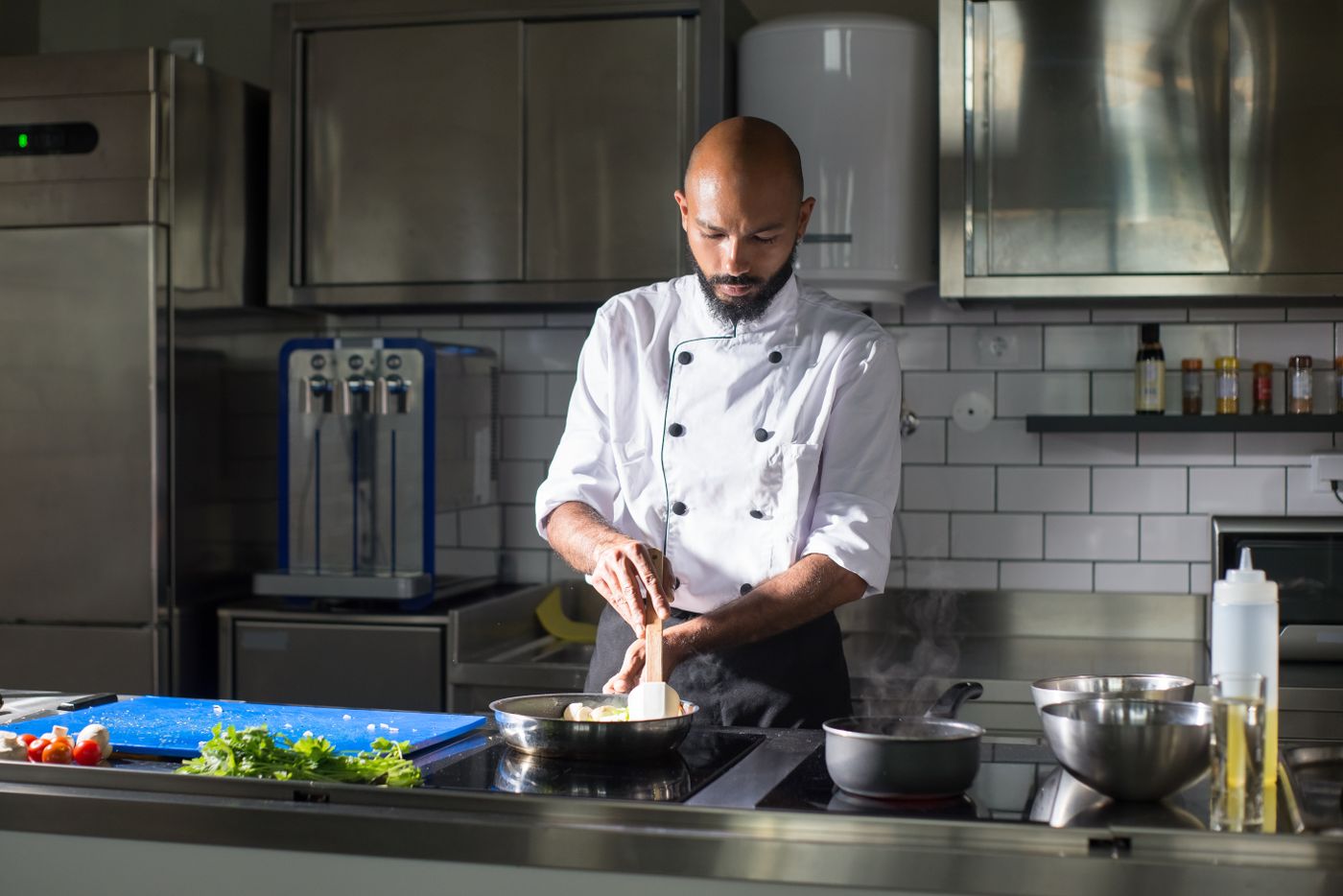 Chef working at the line in a professional restaurant kitchen